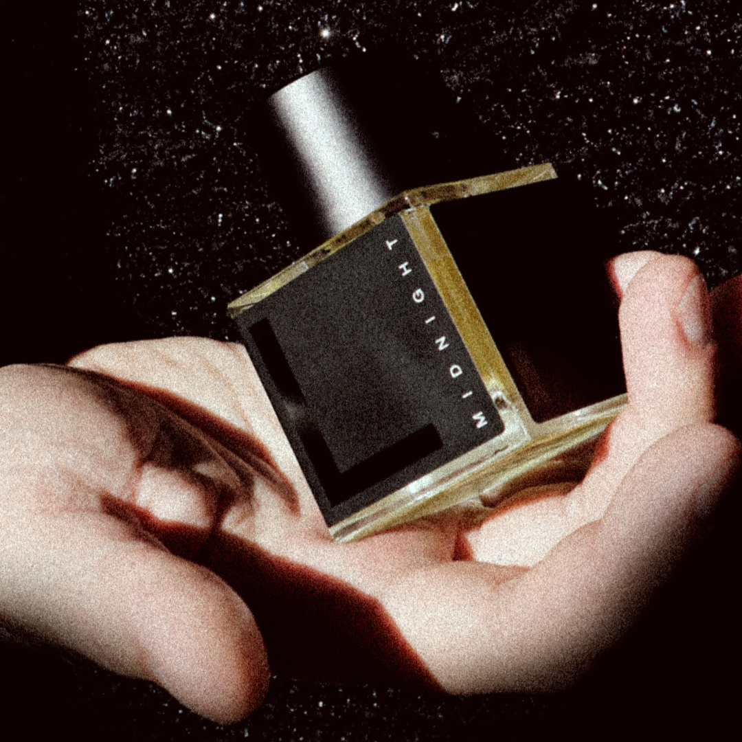 RNDL Midnight Perfume bottle held in a hand with a dark background